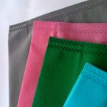 Polypropylene carry bag.  four pieces of polypropylene tote bag in gray, pink, green, blue color on a white background