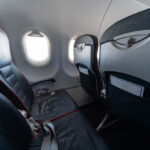 Airplane seats and windows. Economy class comfortable seats without passengers. New low-cost carrier airline