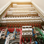 Close up view of electrical panel with fuses and contactors.