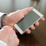 Man holding his smartphone, closeup