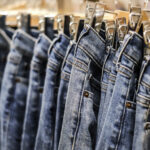 Row of hanged blue jeans pants in shop